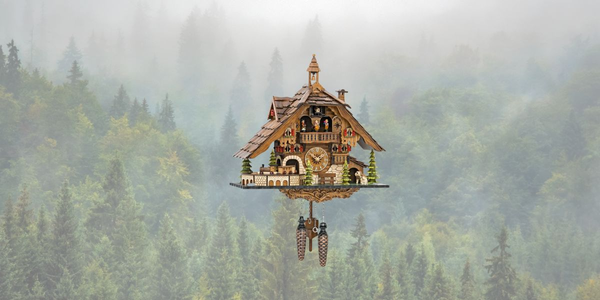 Authentic Black Forest cuckoo clock by Engstler, featuring chalet-style design with animated dancers, woodcutters, a waterwheel, and a moving train – handcrafted in Germany