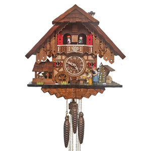 Engstler Cuckoo Clock, a traditional Black Forest masterpiece. Hand-carved details depict a man drinking beer, behind him a woman with a rolling pin. A waterwheel, pine trees, and dancers on the balcony. The cuckoo emerges above, with a shingled roof and chimney.