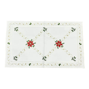 Rectangular white table runner with an outside border of gold swirls and green leaves. Interior border features two red poinsettias, alongside golden swirls of embroidery, and designs of green leaves and fir boughs.