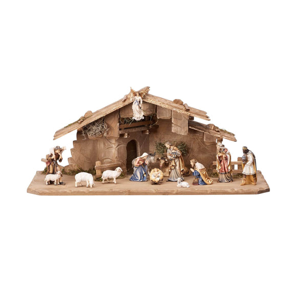 Handcarved wooden nativity set from Tyrol with traditional carved figures and stable.