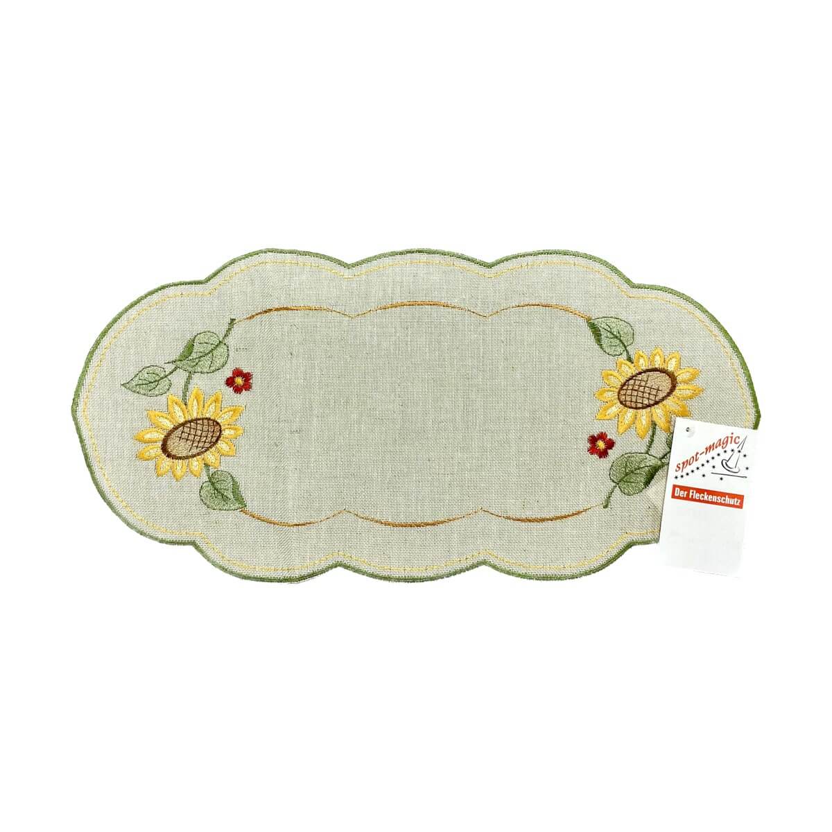 Sand color table runner with scalloped edges, with a border of sunflowers on either end of the runner.