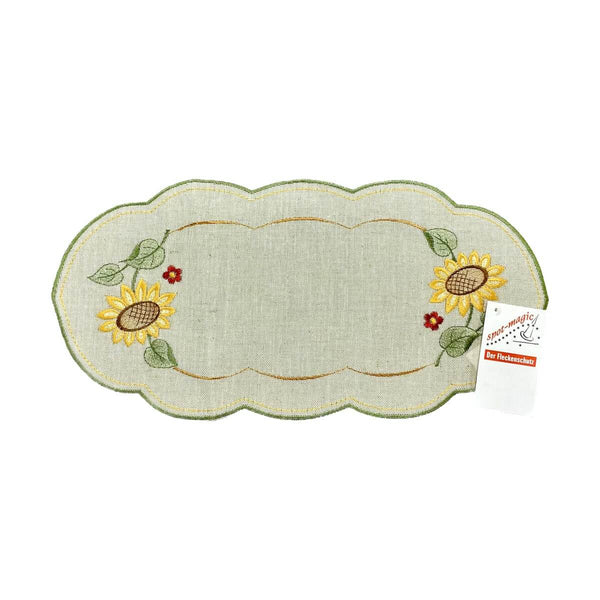 Sand color table runner with scalloped edges, with a border of sunflowers on either end of the runner.