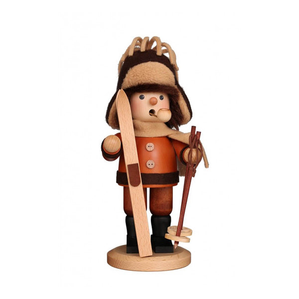 Christian Ulbricht wooden smoker figurine of a skier wearing a fur hat and orange winter coat, holding wooden skis and ski poles, handcrafted in Germany.