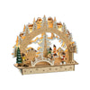 This wooden Pfaff Christmas Schwibbogen is 11.8 x 9.8 x 3.5 inches. It uses battery (3xAA) powered led lights and features a wood grain colored arch above a platform. The arch is lined with white snowcapped trees and houses behind them. The platform features a village scene with four little figurines skiing, sledding, making snowballs and singing Christmas carols. A glittery tree and an arch shaped bridge sit at the center, a green painted tree and wood-colored light post sit on each corner.