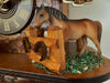 Schneider Cuckoo Clock with brown Horse standing on hay in his paddock with horseshoes on the fencing