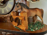 Schneider Cuckoo Clock with brown Horse standing on hay in his paddock with horseshoes on the fencing