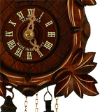 Close up of a  detailed Grape Leaf next to the Dial on a Schneider Traditional Black Forest Cuckoo Clock