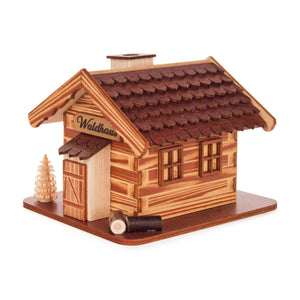 This stunning hand carved German log cabin smoker house holds an incense cone inside and smoke flows from the structure when the smoker house is in use. This house is built in the shape of a log cabin in light and dark shades of wood grain colors. This smoker house is a wonderful companion to a woodsman smoker!