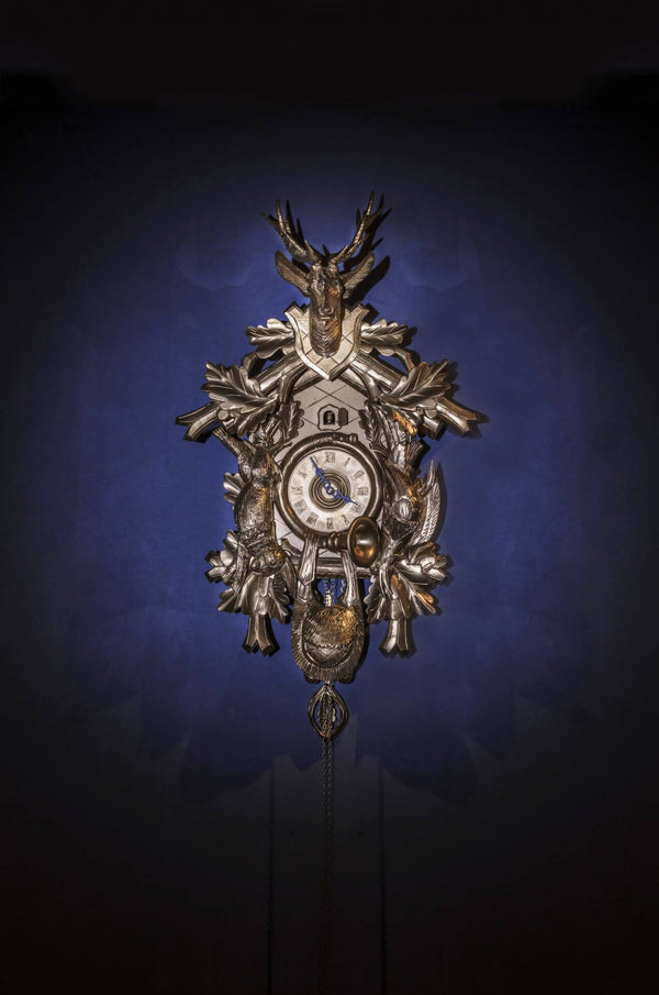 Traditional clock with antique-style clock dial on royal blue background.