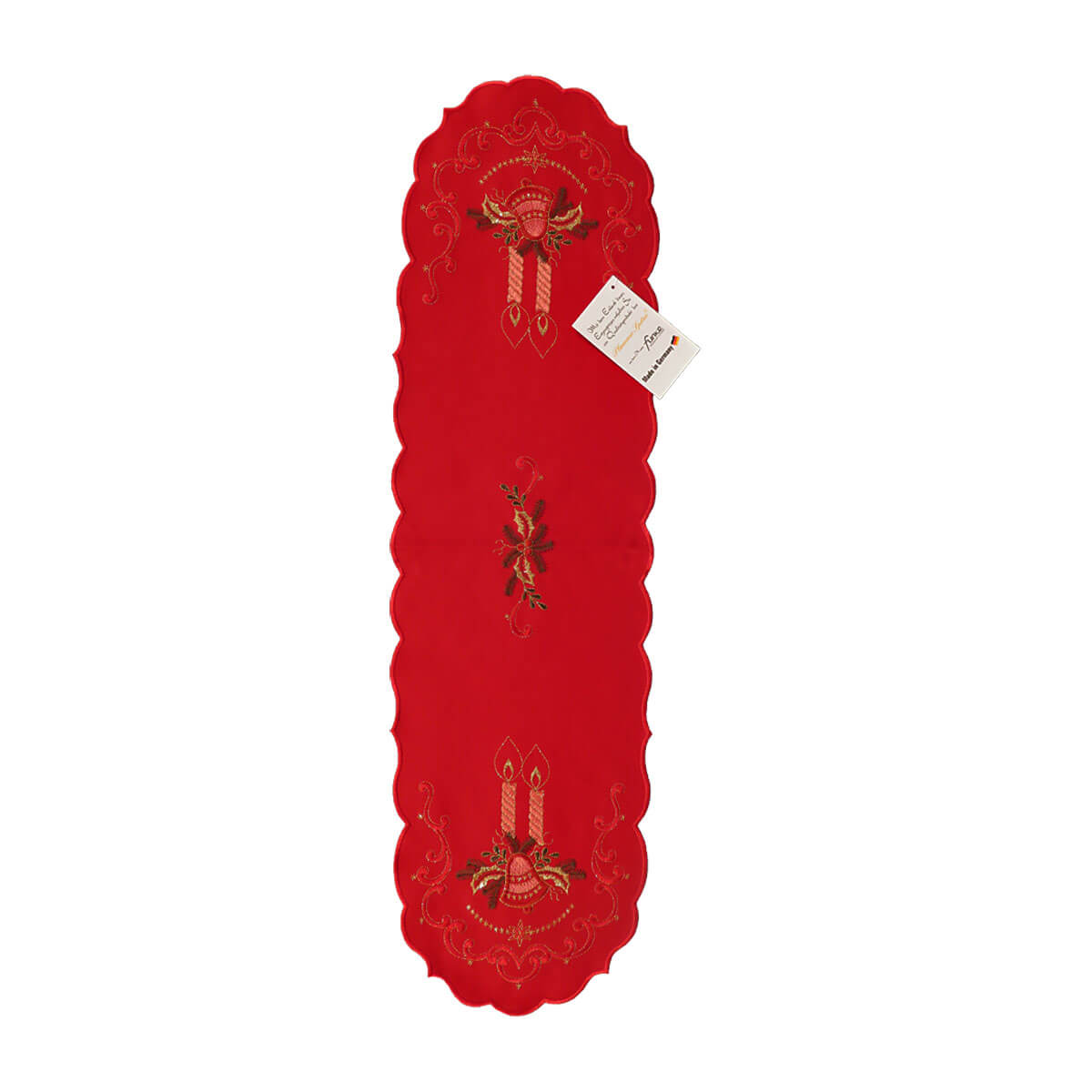 Red table runner with scalloped edges, and a design of candles atop a bell and holly branches on either end, with a design of a holly bough in the center.