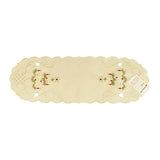 White table runner with scalloped edges, and a design of a Christmas tree with candles and a star atop on either end, along with filigree and cutouts.
