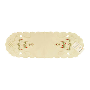 White table runner with scalloped edges, and a design of a Christmas tree with candles and a star atop on either end, along with filigree and cutouts.