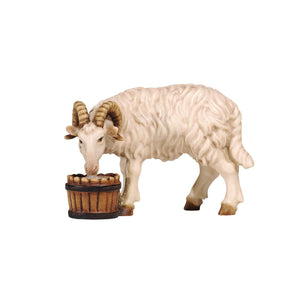 This exquisitely hand-carved PEMA Kostner Nativity white ram figure is perfect for adding a classic touch to your holiday decorations. The highly detailed, hand-carved wood figure stands with curly horns and looks to the left while eating from the wooden bucket in front of it. Truly a timeless piece!