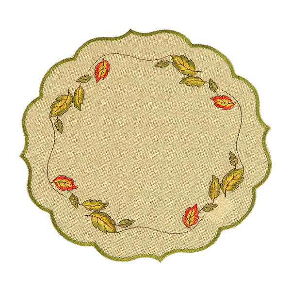Round sand color table linen with green scalloped edges, and a border of fall leaves blowing in the wind.