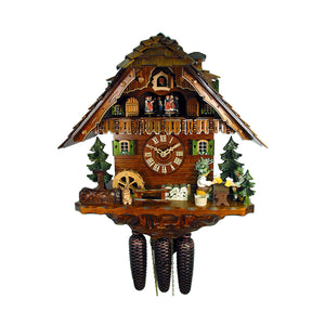 8-Day Chalet August Schwer Black Forest coocoo clock The solid wood clock features a water pump and trough in front of a green tree on the left. A bunny sits in front of a water wheel, next to a fence. A log pile is stacked underneath the dial and two men in Lederhosen are enjoying their beers at a table next to two green trees. Two windows with green shutters and flowers decorate both sides of the dial. Dancers spin on the balcony above. The cuckoo comes out from his door above. 