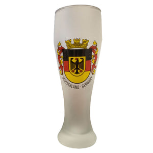 Frosted wheat beer glass with a design of an eagle against a German flag crest, bordered by red and yellow banners and a castle turret on top.
