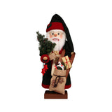 Christian Ulbricht Nutcracker Santa Claus in dark green coat and hat with red trim, holding a sleigh and sack of gifts, embodying festive holiday charm.