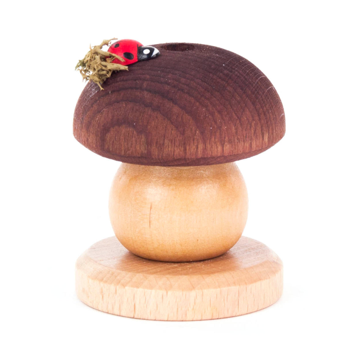A small wooden German smoker house in the shape of a mushroom with a ladybug on top.