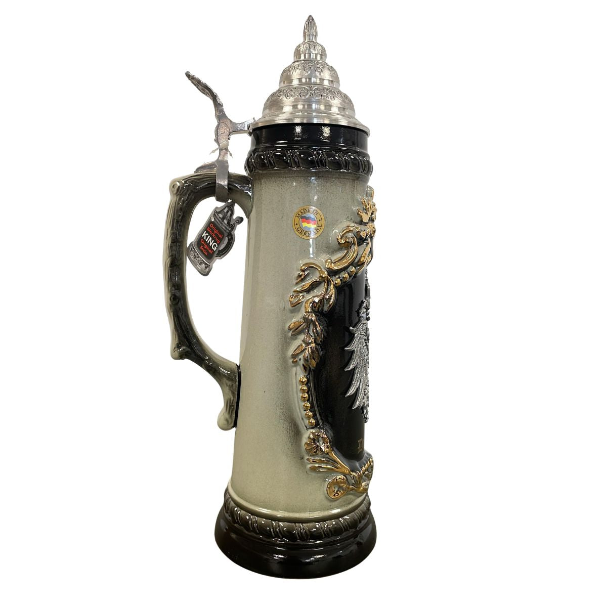 Decorative beer stein with intricate designs and a silver lid on a white background