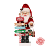 Santa Claus figurine dressed in a red coat, pants, and hat with white trim, standing behind a signpost labeled "North Pole," holding gifts, with festive details.