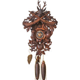 Behold this splendid hunter-style cuckoo clock, with a rich dark stain and a majestic stag head displaying grand antlers. The dial is surrounded by carvings of rabbits, pheasants, gun pouch, oak leaves, and intricate tracery work. A truly remarkable timepiece for those passionate about hunting.