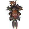 8-Day Traditional Black Forest coocoo clock. The face of the wooden clock around the dial is crosshatched. The frame around the edge of the clock box is decorated with green carved leaves on a vine. A cuckoo bird is sitting on each side of the clock looking towards the dial, eating blue berries. The top of the clock is decorated with a leafy vine and a cuckoo bird with its spread wings is sitting at the very top of the crown.