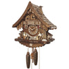 Image of Engstler 8-Day Cuckoo Clock depicting a Bavarian man drinking beer while watching a wood chopper at work. The clock resembles a wooden cabin with red shutters, a St. Bernard in front of a doghouse on one side, and a well on the other side