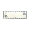 White linen table runner with Blue Onion embroidery, blue onion motifs around the rim, and blue flowers blooming from two corners.