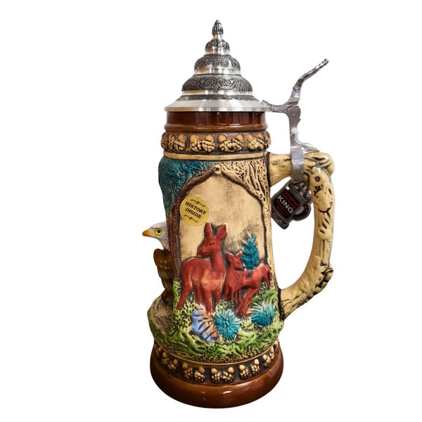 Side of a King Beer Stein with three deer in a wooded area. The brown and green tones of the Mug underline the nature scenes