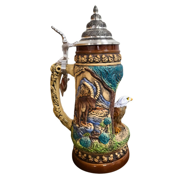 Side of a KING Beer Stein with an ibex standing attentively in his environment. The brown and green tones of the Mug underline the nature scenes.