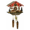 Trenkle chalet-style cuckoo clock with red roof, beer drinker figure, moving waterwheel, edelweiss decor, and warm lights illuminating the cuckoo bird.