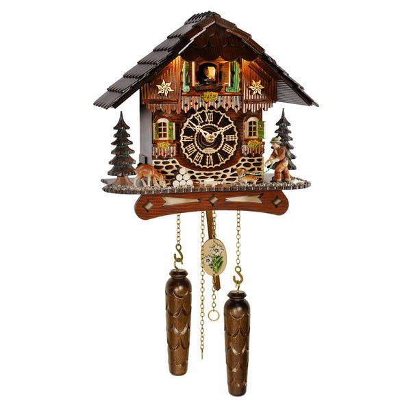 Trenkle chalet cuckoo clock with deer, dachshund, green shutters, edelweiss detail, wood weights, and roof lights illuminating the cuckoo bird.