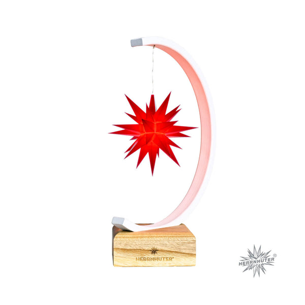 A red 25-pointed Moravian Christmas star with a metallic arch and a wooden base, including a battery holder.