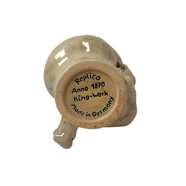 Bottom of beer stein displaying engraved text: “Replica Anno 1870 King-Werk Made in Germany” with underglaze finish on ceramic base.