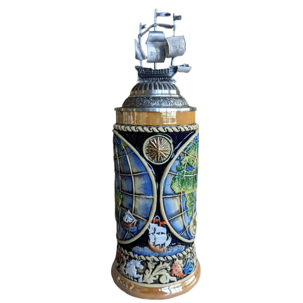 front of A vintage-style beer stein featuring an old-world map adorned with the iconic ships of explorers from bygone eras. The lower rim showcases intricate symbols representing the four elements: Fire, Earth, Wind, and Water. The pewter lid is adorned with a globe and a majestic sailing ship, adding a touch of historical charm to the ornate design.
