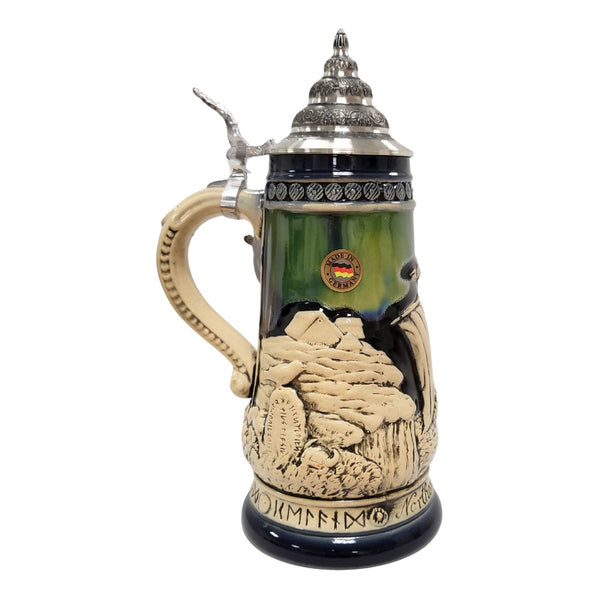 German beer stein with Viking ship, Norse warriors, runestone, village, and Northern Lights in blue and green colors, 0.5L. side with village

