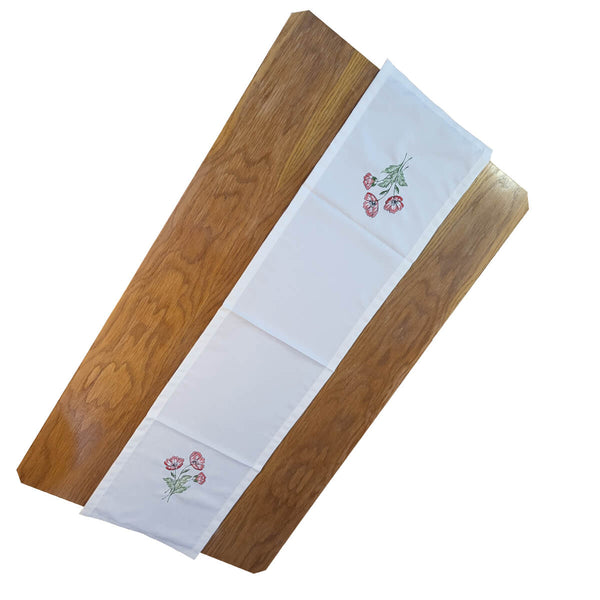 Poppy Blossom Linen Table Runner with vibrant red poppy flowers and lush green stems on white background.