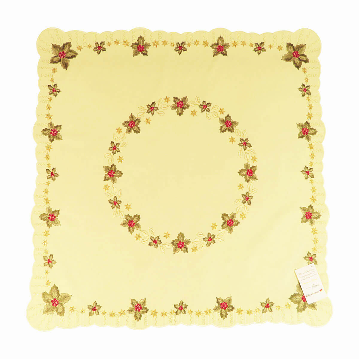 Square champagne color table cloth, with a circle of holly leaves and Christmas stars in the center, and a border of holly leaves and stars around the edges.