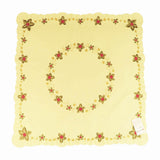 Square champagne color table cloth, with a circle of holly leaves and Christmas stars in the center, and a border of holly leaves and stars around the edges.