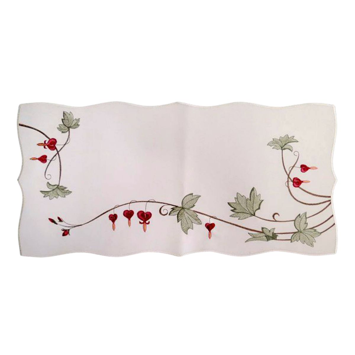 White embroidered linen table runner featuring traditional bleeding heart flowers, green vine accents, and scalloped edges in a German-inspired floral design.
