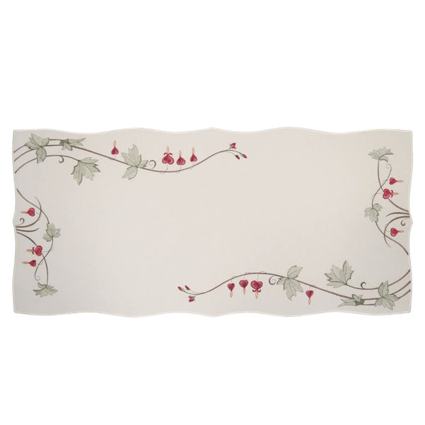 White linen table runner with embroidered bleeding hearts and green vine border, scalloped edges, large size
