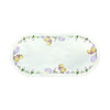 Oval white table runner with scalloped edges, with a border of yellow chicks wearing bows, pink eggs, and a field of daisies.