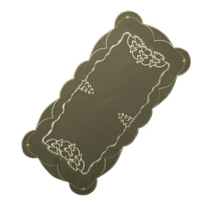 Rectangular linen table runner in winter green with white embroidered fir trees and gold stars in each corner.