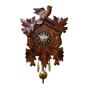 This miniature traditional-style Quartz Clock showcases a classic Black Forest design with three birds. One bird sits on the top, while two more adorn the sides. The clock also has ivy leaves and brass-colored decorative weights, enhancing its elegant design and traditional craftsmanship. The brass pendulum adds a gentle sway, making it a truly timeless piece.