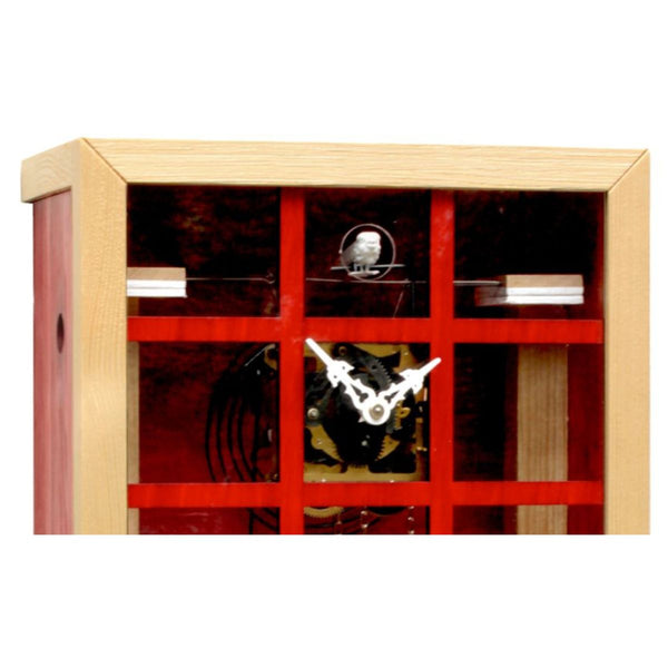 Detailed view of the EINBLICK red glass front cuckoo clock, highlighting gears,  inner mechanical movement and cuckoo bird.