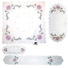 Ombre Christmas Ornaments Collection table linens, including a square tablecloth, oval runners, long runner, and doily. Embroidered with purple ombre ornaments, pine branches, golden stars, and delicate cutout designs. Handcrafted in Germany, perfect for festive holiday decor.