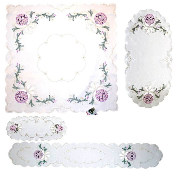 Ombre Christmas Ornaments Collection table linens, including a square tablecloth, oval runners, long runner, and doily. Embroidered with purple ombre ornaments, pine branches, golden stars, and delicate cutout designs. Handcrafted in Germany, perfect for festive holiday decor.