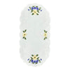 White oval table runner with scalloped edges, a border of yellow blossoms and white swirls, and a design of spring flowers on either end.
