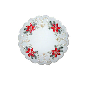 Round white table linen with border design of red poinsettias with leaves and a swirling gold design with stars.