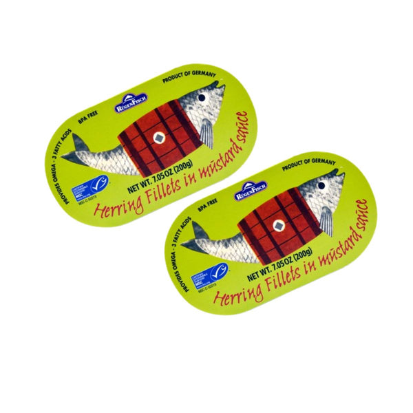 Two oval packages of Bluefish Herring Fillets in mustard sauce, displayed on a clean white background.
